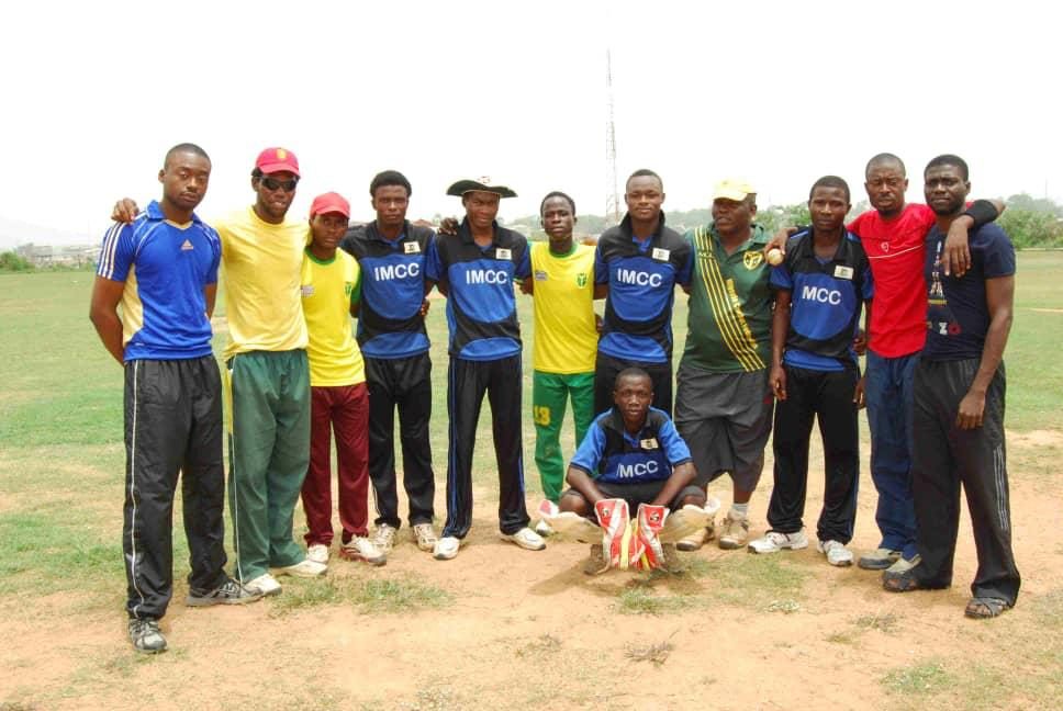 IMCC players and officials gathered on the field after a match