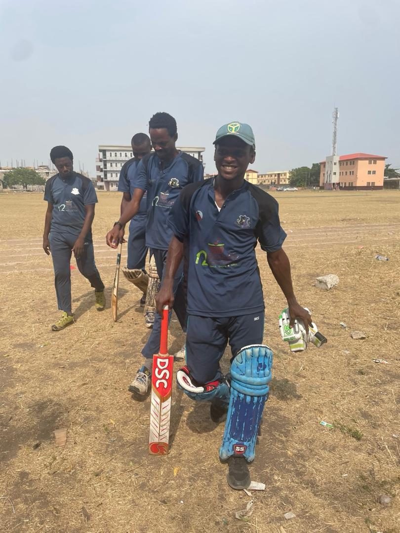 A young IMCC batsman padded up and holding his bat on the ground
